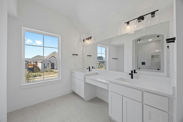 bathroom with walk in shower, vanity, and a healthy amount of sunlight