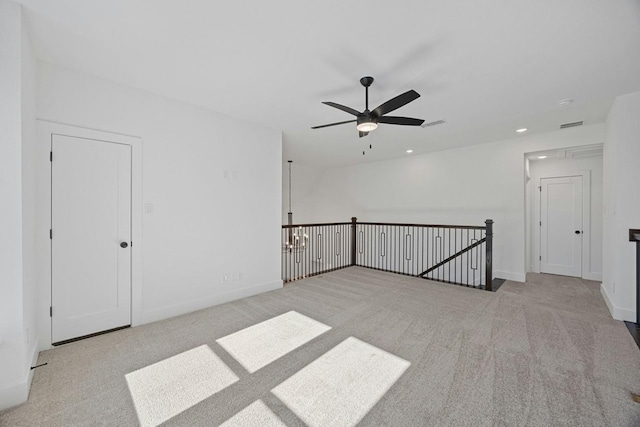 carpeted spare room with ceiling fan