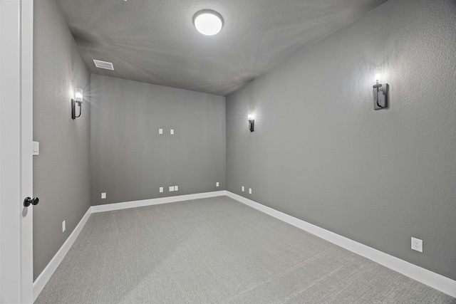 basement with carpet and a textured ceiling