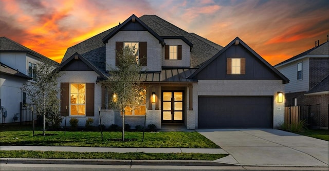 view of front facade with a garage and a lawn