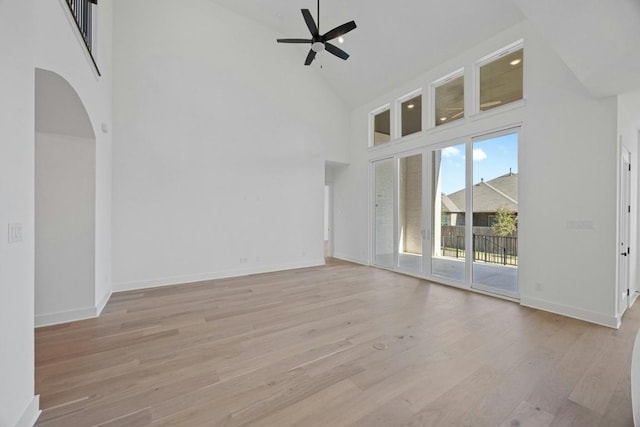 unfurnished living room featuring ceiling fan, high vaulted ceiling, and light hardwood / wood-style flooring