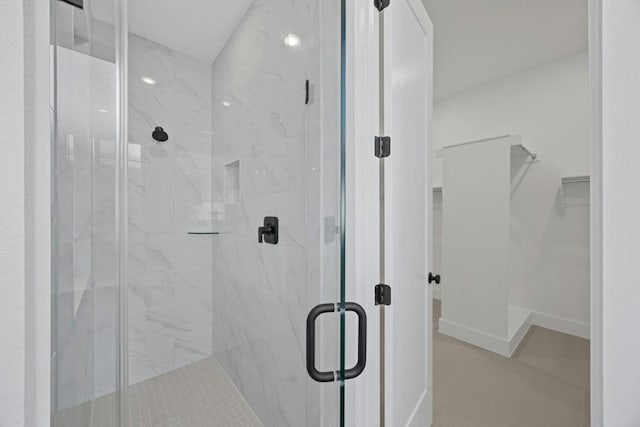 bathroom with tile patterned flooring and a shower with door