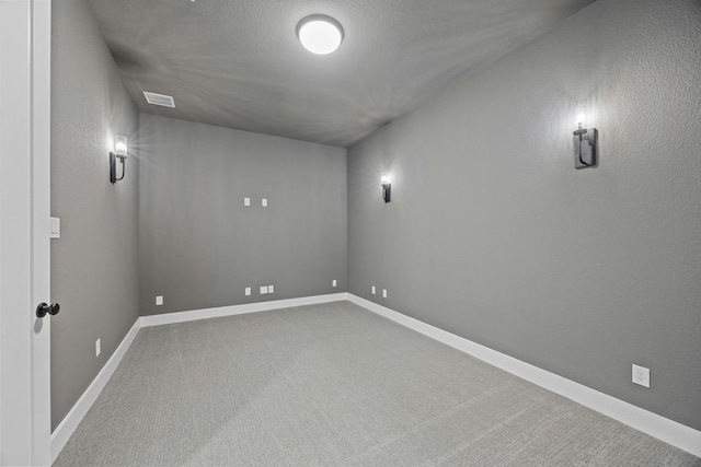 basement with a textured ceiling and carpet