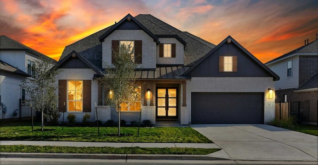 view of front of home featuring a garage and a lawn