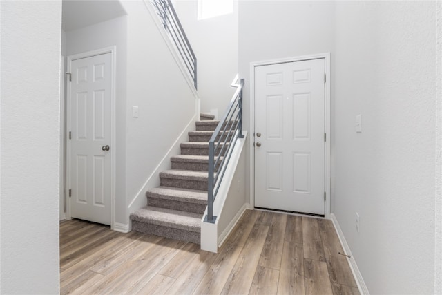 staircase with hardwood / wood-style flooring