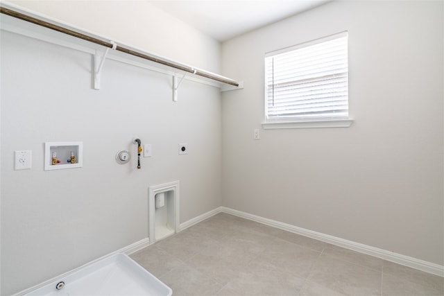 washroom with hookup for an electric dryer, hookup for a washing machine, hookup for a gas dryer, and light tile patterned floors