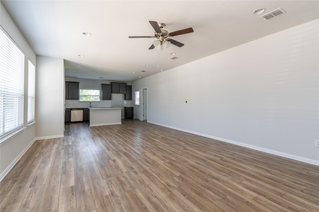 unfurnished living room featuring hardwood / wood-style floors and ceiling fan