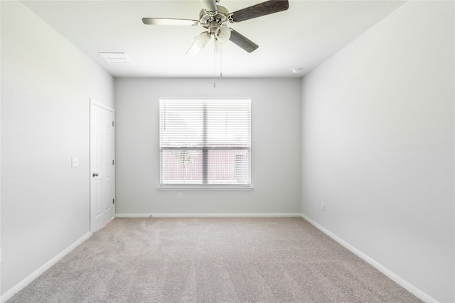 unfurnished room featuring ceiling fan and carpet