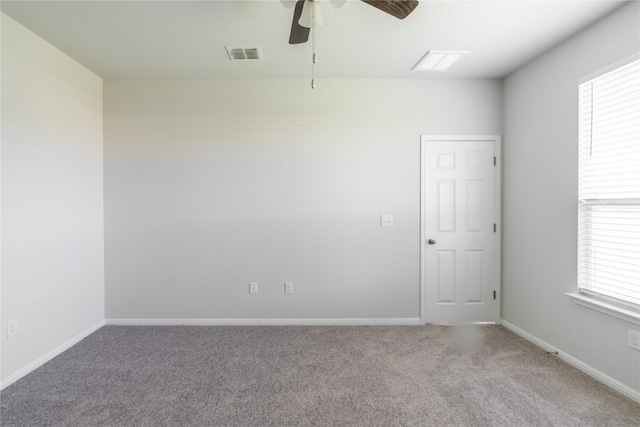 carpeted empty room with ceiling fan and a healthy amount of sunlight