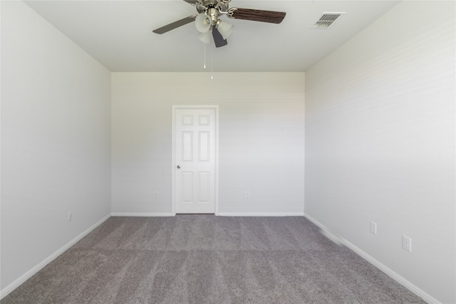 carpeted spare room with ceiling fan