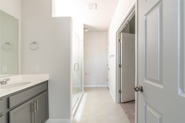 bathroom featuring vanity, walk in shower, and tile patterned flooring