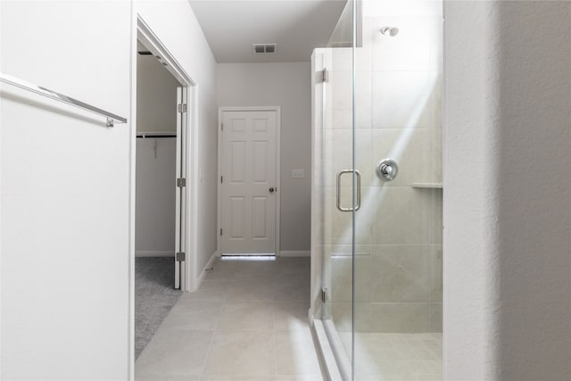 bathroom featuring an enclosed shower and tile patterned flooring