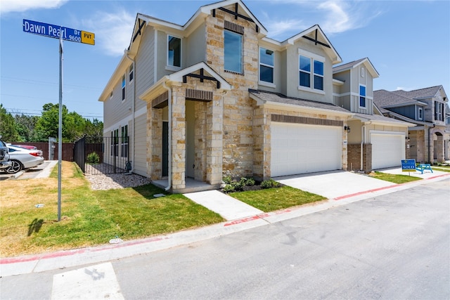 multi unit property featuring a front lawn and a garage