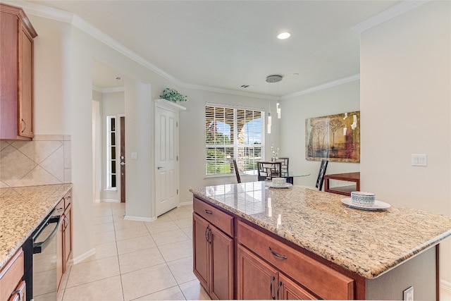 kitchen with light tile patterned floors, crown molding, a kitchen island, and backsplash