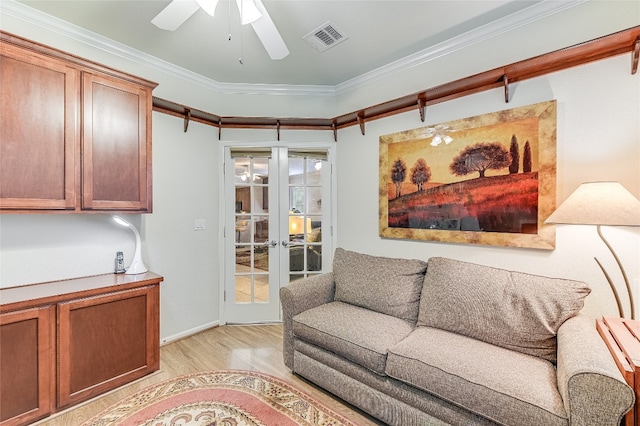 living room with ceiling fan, crown molding, light hardwood / wood-style flooring, and french doors