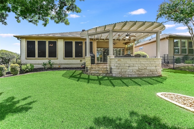 back of house featuring a pergola and a yard