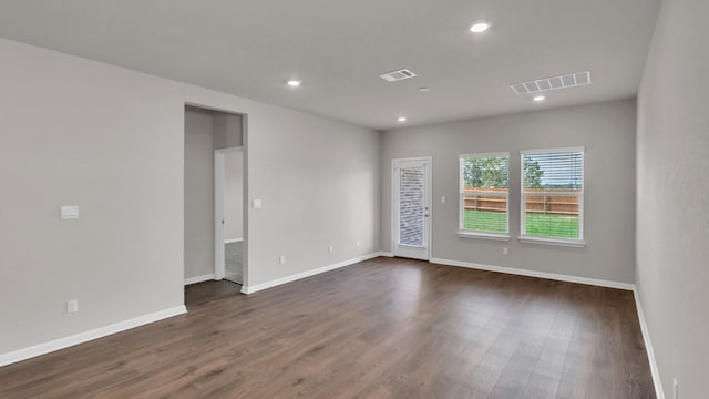 unfurnished room with dark hardwood / wood-style flooring