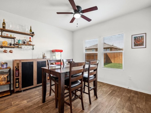 19104 Romano Dr, Elgin, TX 78621 - dining room with a bar, a ceiling fan, wood finished floors, and baseboards