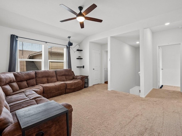 living room with lofted ceiling, recessed lighting, light colored carpet, a ceiling fan, and baseboards