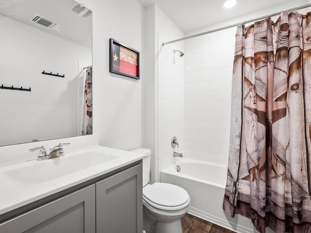 bathroom featuring shower / tub combo with curtain, visible vents, toilet, vanity, and wood finished floors