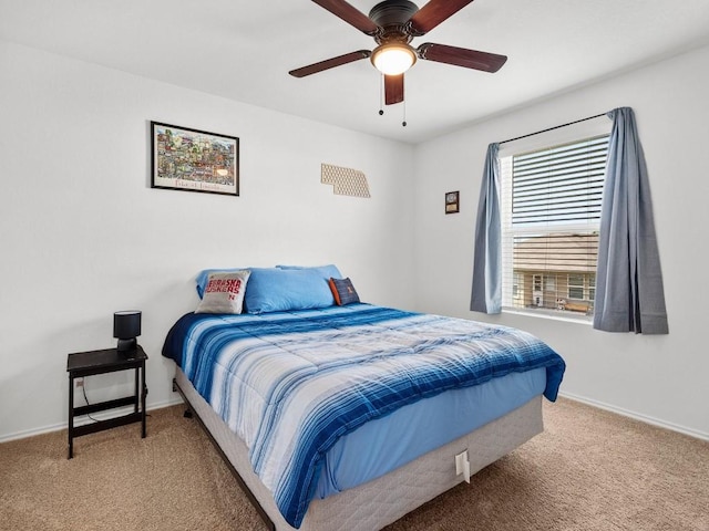 bedroom featuring a ceiling fan, light colored carpet, and baseboards