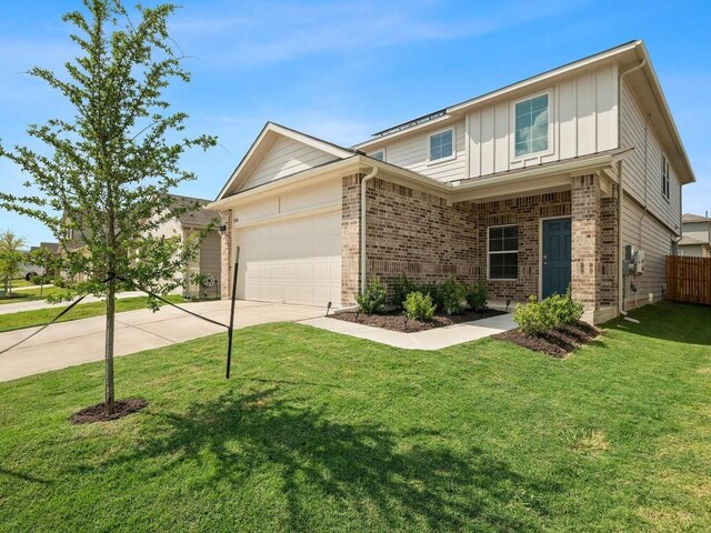 view of front of property featuring a garage and a front lawn