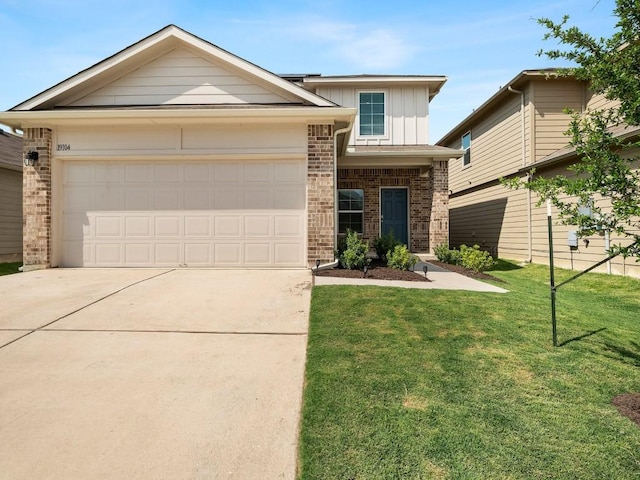 19104 Romano Dr, Elgin, TX 78621 - view of front of house with brick siding, board and batten siding, concrete driveway, a front lawn, and a garage