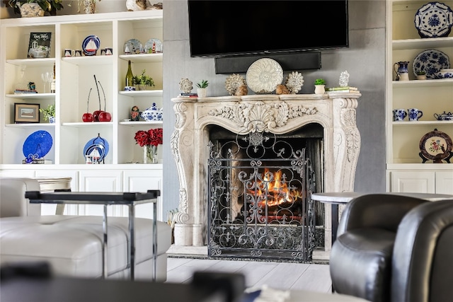 living room featuring a fireplace and built in features