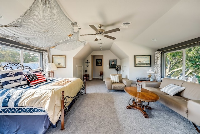 carpeted bedroom featuring ceiling fan, vaulted ceiling, and multiple windows