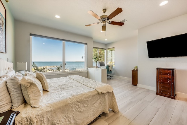 bedroom with light hardwood / wood-style flooring and ceiling fan