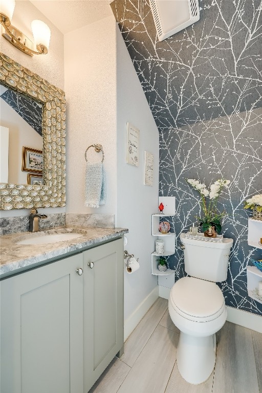 bathroom featuring hardwood / wood-style floors, vanity, and toilet