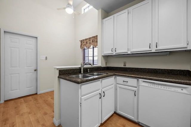 kitchen with white cabinetry, white dishwasher, kitchen peninsula, and sink