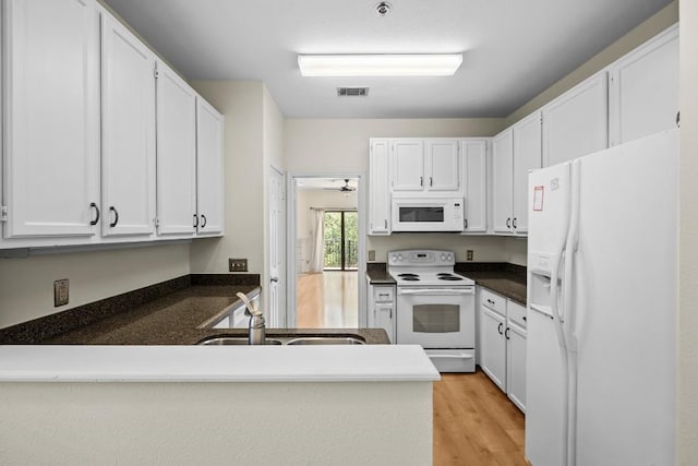 kitchen featuring white cabinetry, sink, white appliances, and light wood-type flooring