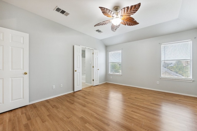 unfurnished bedroom with light hardwood / wood-style flooring, lofted ceiling, and ceiling fan