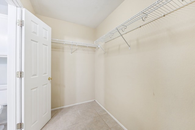 spacious closet featuring light tile patterned floors