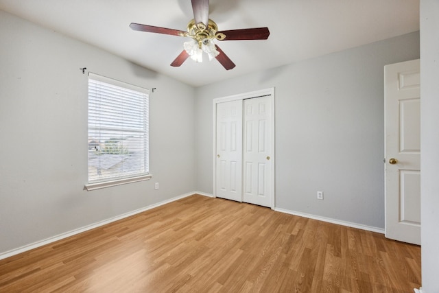 unfurnished bedroom with ceiling fan, a closet, and light hardwood / wood-style floors