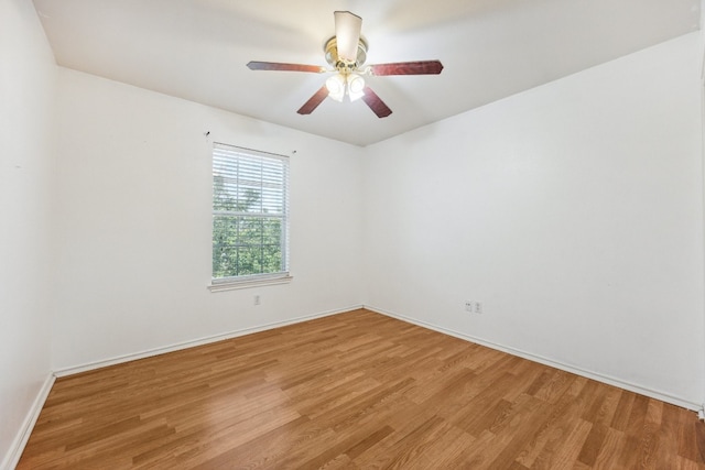 empty room featuring hardwood / wood-style floors and ceiling fan