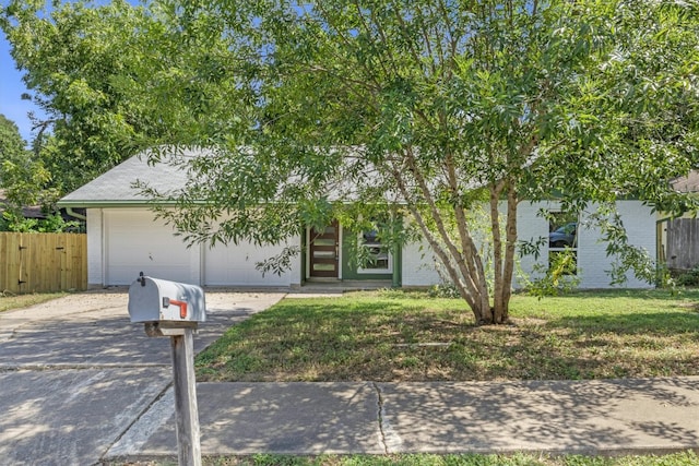 view of front of property with a garage and a front lawn