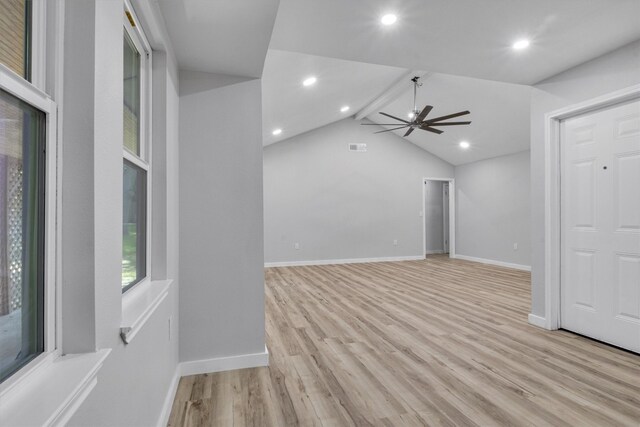 unfurnished living room featuring ceiling fan, light hardwood / wood-style floors, and vaulted ceiling