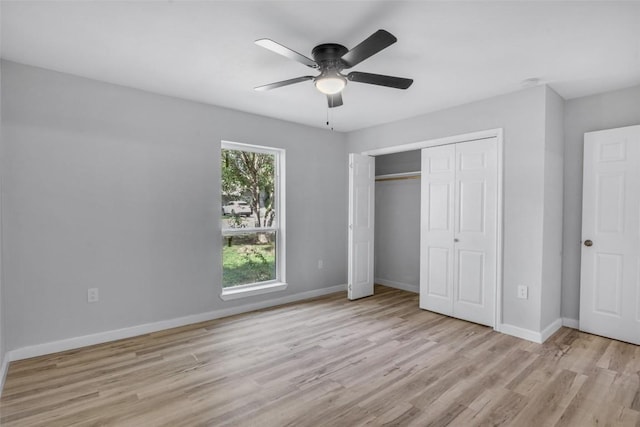 unfurnished bedroom with light hardwood / wood-style floors, a closet, and ceiling fan