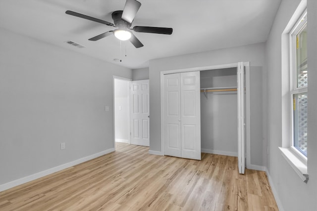 unfurnished bedroom featuring light wood-type flooring, a closet, and ceiling fan