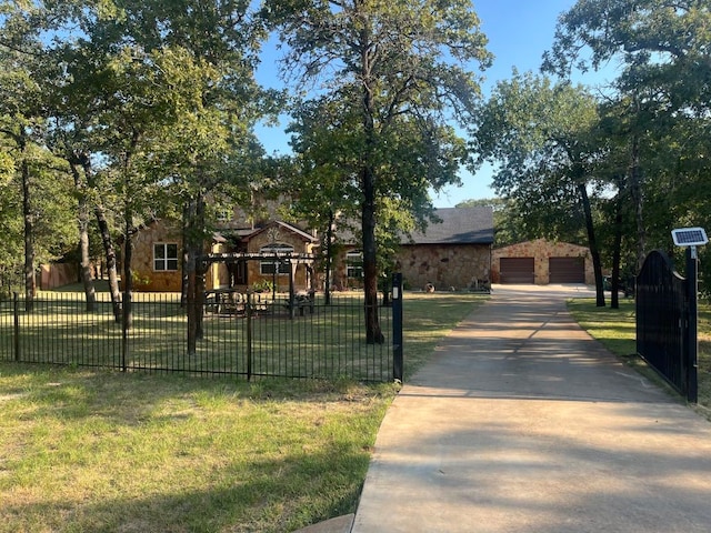 view of front facade with a garage, a front lawn, and an outdoor structure