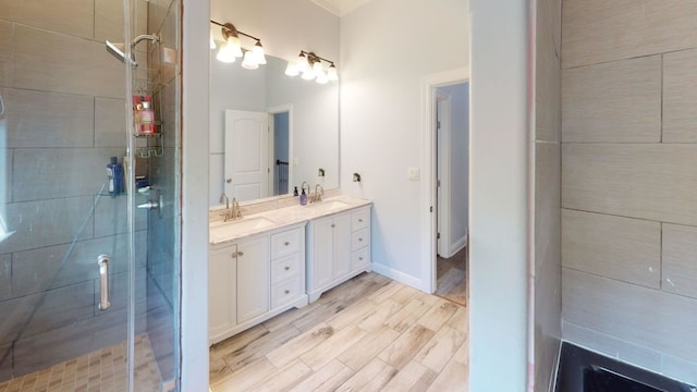 bathroom with vanity and a shower with door