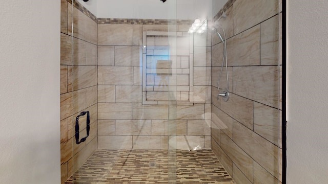 bathroom with tiled shower