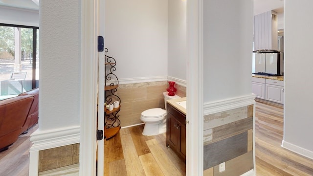 bathroom featuring vanity, hardwood / wood-style flooring, and toilet