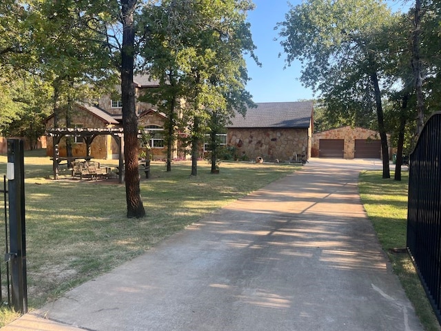 view of front of house with a front yard, an outdoor structure, and a garage