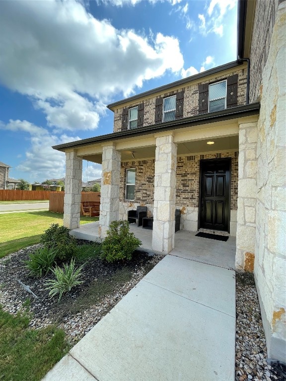 view of exterior entry with a yard