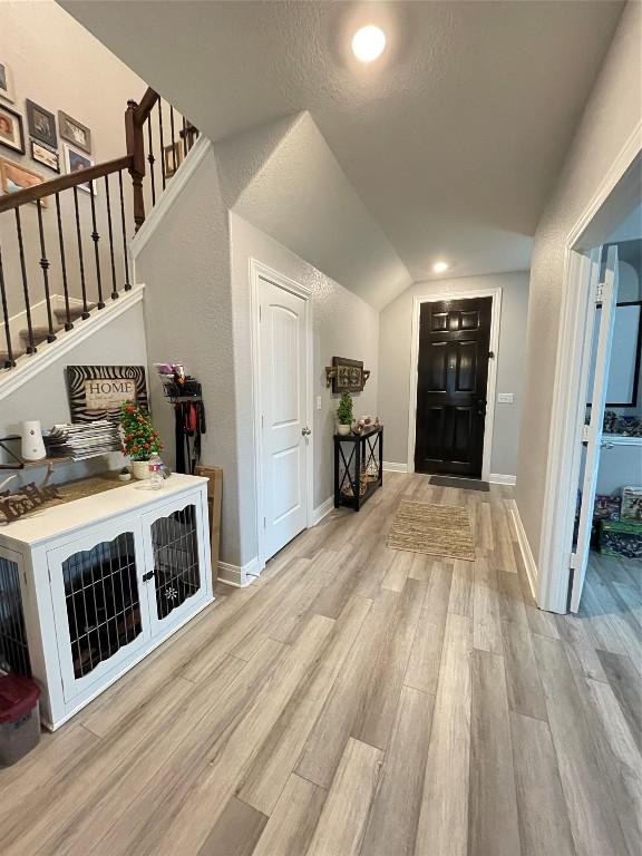 interior space featuring light hardwood / wood-style flooring and vaulted ceiling