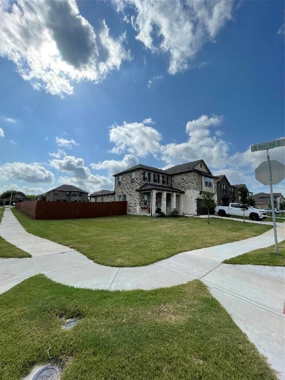 view of property's community featuring a lawn