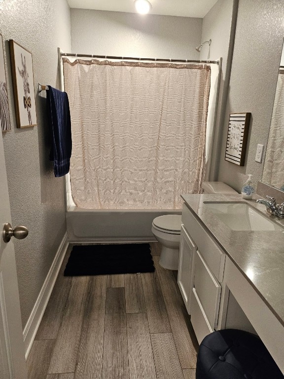 full bathroom with shower / bath combo with shower curtain, toilet, vanity, and wood-type flooring